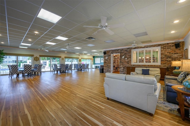 1350 N Portofino Dr Unit 208, Sarasota, FL 34242 - living area featuring a ceiling fan, wood finished floors, brick wall, and recessed lighting