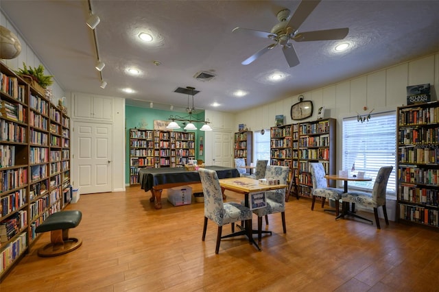 1350 N Portofino Dr Unit 208, Sarasota, FL 34242 - dining space featuring wood finished floors, a ceiling fan, and a textured ceiling