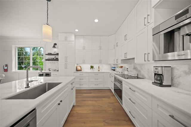 120 White Ave, Anna Maria, FL 34216 - kitchen featuring a sink, stainless steel appliances, light countertops, white cabinets, and recessed lighting