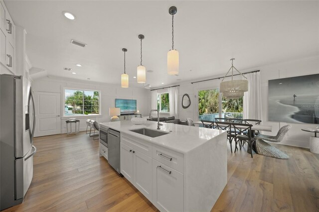 120 White Ave, Anna Maria, FL 34216 - kitchen with appliances with stainless steel finishes, a sink, white cabinetry, plenty of natural light, and recessed lighting