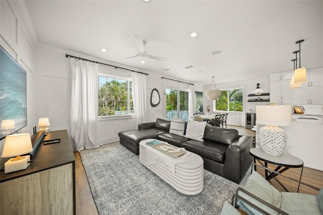120 White Ave, Anna Maria, FL 34216 - living room featuring light wood-style flooring, plenty of natural light, a ceiling fan, and recessed lighting