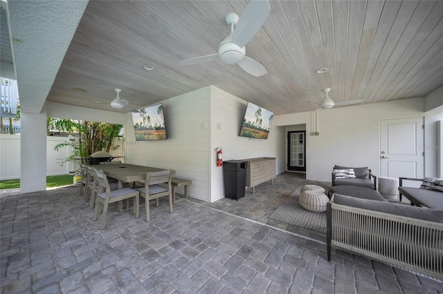 120 White Ave, Anna Maria, FL 34216 - living room with a ceiling fan, wooden ceiling, and wood walls
