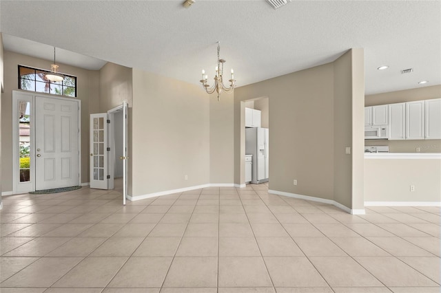 8118 Stirling Falls Cir, Sarasota, FL 34243 - entryway featuring a chandelier, light tile patterned floors, recessed lighting, and a textured ceiling