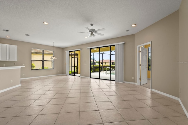 8118 Stirling Falls Cir, Sarasota, FL 34243 - unfurnished living room with plenty of natural light, recessed lighting, ceiling fan, a textured ceiling, and light tile patterned floors