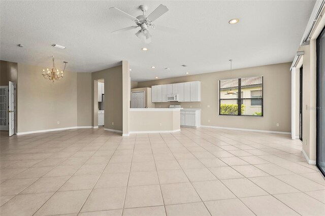 8118 Stirling Falls Cir, Sarasota, FL 34243 - unfurnished living room with a chandelier, a ceiling fan, recessed lighting, and light tile patterned floors
