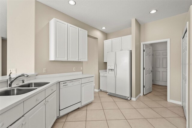 8118 Stirling Falls Cir, Sarasota, FL 34243 - kitchen featuring white appliances, white cabinets, light countertops, and recessed lighting