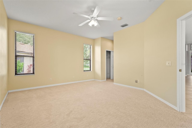 8118 Stirling Falls Cir, Sarasota, FL 34243 - spare room featuring light carpet, healthy amount of natural light, a ceiling fan, and a smoke detector