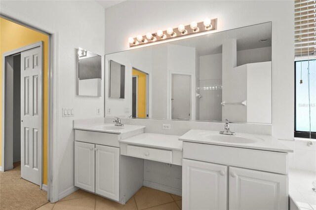8118 Stirling Falls Cir, Sarasota, FL 34243 - bathroom with double vanity, tile patterned floors, and a bathtub