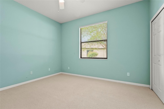 8118 Stirling Falls Cir, Sarasota, FL 34243 - unfurnished bedroom with light colored carpet, a closet, and a ceiling fan
