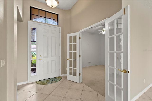 8118 Stirling Falls Cir, Sarasota, FL 34243 - tiled entrance foyer featuring french doors, a ceiling fan, and a high ceiling