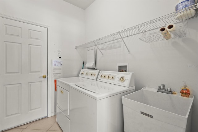8118 Stirling Falls Cir, Sarasota, FL 34243 - laundry room with washer and dryer and light tile patterned flooring