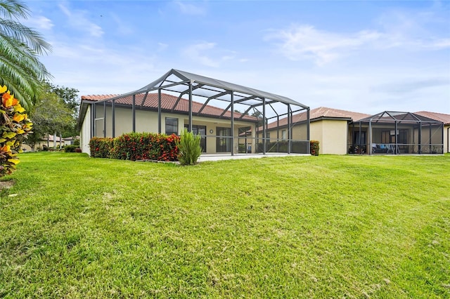 8118 Stirling Falls Cir, Sarasota, FL 34243 - rear view of property featuring a lawn, stucco siding, and a lanai