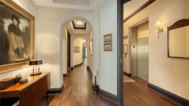 420 Golden Gate Pt Unit 200A, Sarasota, FL 34236 - corridor with arched walkways, a raised ceiling, dark wood finished floors, and baseboards
