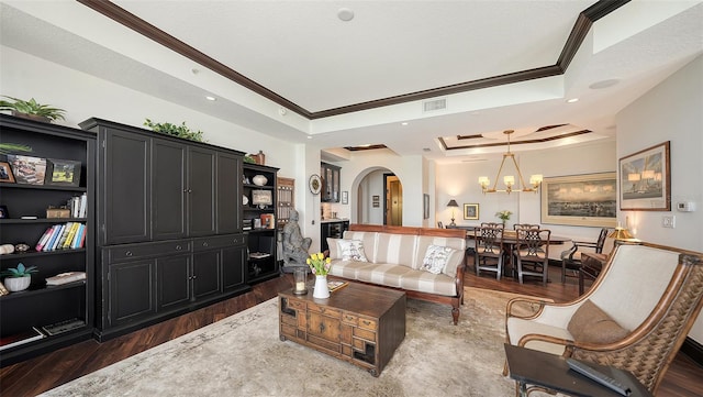 420 Golden Gate Pt Unit 200A, Sarasota, FL 34236 - living room with crown molding, arched walkways, dark wood-style flooring, a chandelier, and a raised ceiling