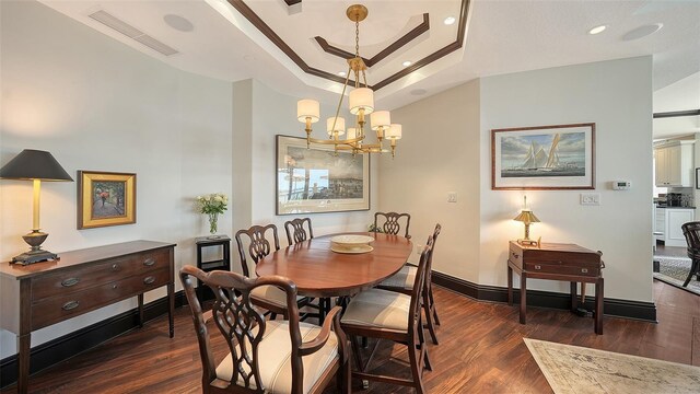 420 Golden Gate Pt Unit 200A, Sarasota, FL 34236 - dining space with wood finished floors, a chandelier, a tray ceiling, baseboards, and recessed lighting