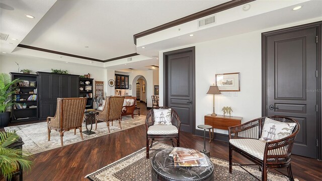420 Golden Gate Pt Unit 200A, Sarasota, FL 34236 - living area with arched walkways, wood finished floors, recessed lighting, baseboards, and a tray ceiling