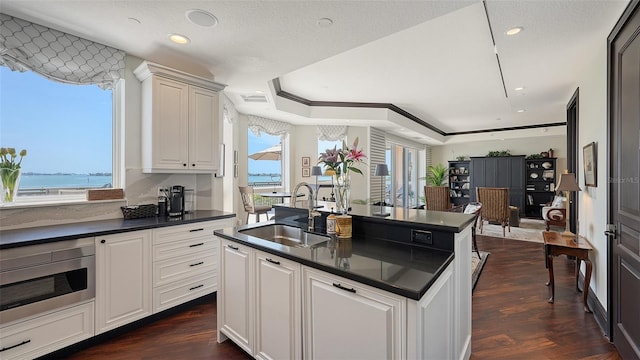 420 Golden Gate Pt Unit 200A, Sarasota, FL 34236 - kitchen with a sink, dark countertops, plenty of natural light, dark wood finished floors, and recessed lighting