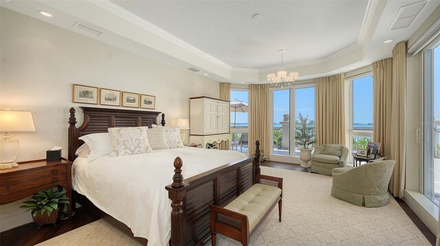 420 Golden Gate Pt Unit 200A, Sarasota, FL 34236 - bedroom featuring a chandelier, a raised ceiling, crown molding, multiple windows, and recessed lighting