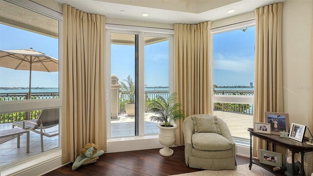 420 Golden Gate Pt Unit 200A, Sarasota, FL 34236 - sitting room with wood finished floors, healthy amount of natural light, a water view, and recessed lighting