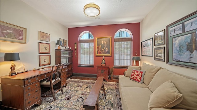 420 Golden Gate Pt Unit 200A, Sarasota, FL 34236 - home office featuring wood finished floors, a textured ceiling, and baseboards