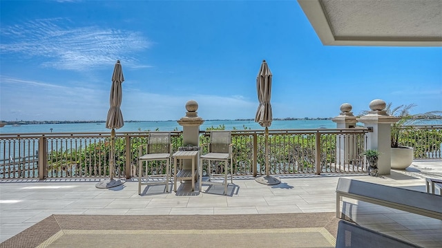 420 Golden Gate Pt Unit 200A, Sarasota, FL 34236 - view of patio featuring a water view and a balcony