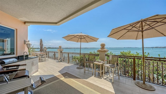 420 Golden Gate Pt Unit 200A, Sarasota, FL 34236 - view of patio / terrace with a water view and a sink