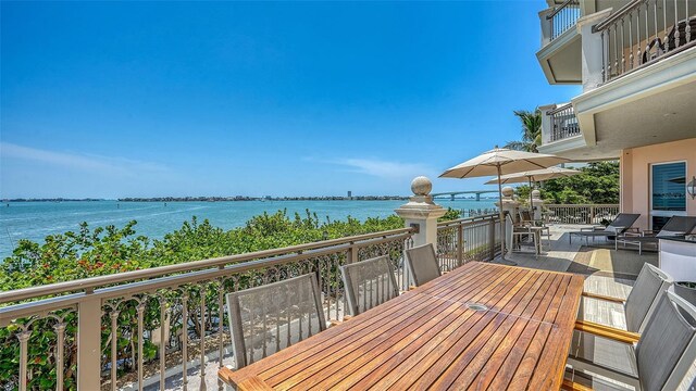 420 Golden Gate Pt Unit 200A, Sarasota, FL 34236 - wooden terrace featuring a water view and outdoor dining area