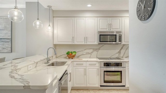 606 Riviera Dunes Way Unit 306, Palmetto, FL 34221 - kitchen featuring stainless steel appliances, a sink, a peninsula, white cabinetry, and recessed lighting