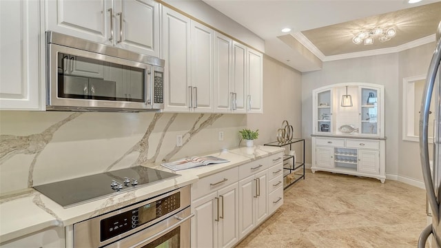 606 Riviera Dunes Way Unit 306, Palmetto, FL 34221 - kitchen with stainless steel appliances, white cabinetry, crown molding, recessed lighting, and baseboards