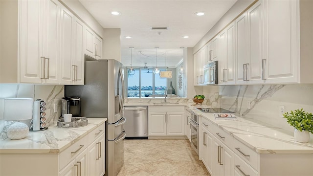 606 Riviera Dunes Way Unit 306, Palmetto, FL 34221 - kitchen with stainless steel appliances, a sink, backsplash, recessed lighting, and white cabinets