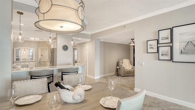 606 Riviera Dunes Way Unit 306, Palmetto, FL 34221 - dining space featuring crown molding, baseboards, ceiling fan, and light tile patterned floors