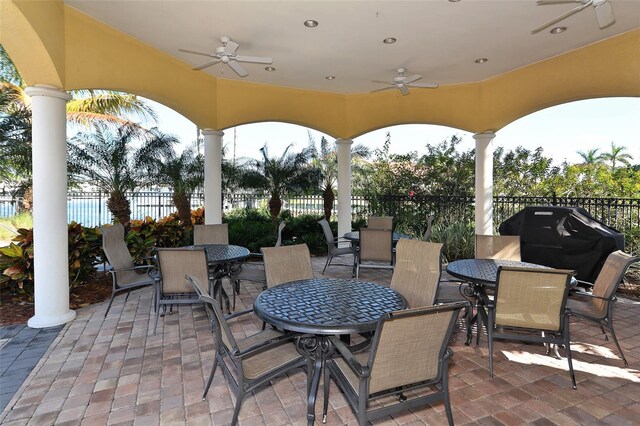 606 Riviera Dunes Way Unit 306, Palmetto, FL 34221 - view of patio with outdoor dining area, a ceiling fan, and fence