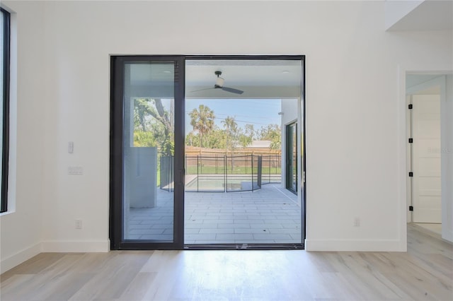 2335 Oak Ter, Sarasota, FL 34231 - doorway to outside featuring ceiling fan, baseboards, and wood finished floors
