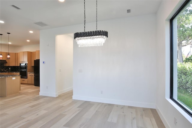 2335 Oak Ter, Sarasota, FL 34231 - unfurnished dining area with plenty of natural light, light wood-style flooring, recessed lighting, and a chandelier