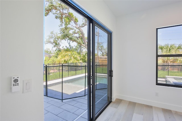 2335 Oak Ter, Sarasota, FL 34231 - doorway with light wood-type flooring and baseboards