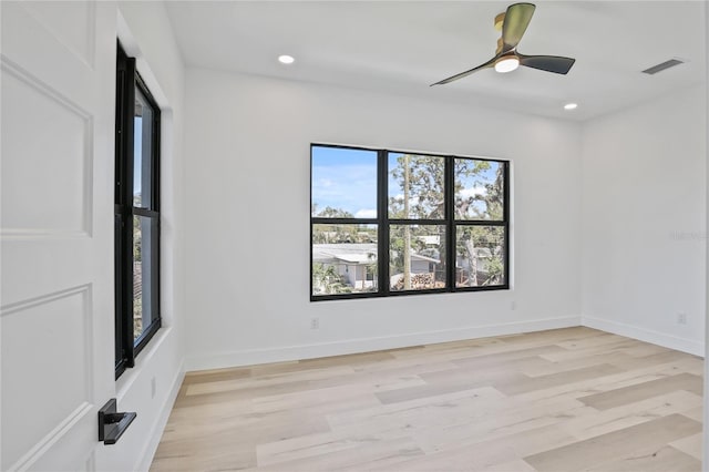 2335 Oak Ter, Sarasota, FL 34231 - spare room featuring healthy amount of natural light, light wood-style flooring, a ceiling fan, recessed lighting, and baseboards