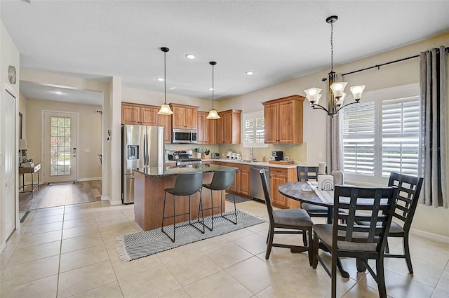 12149 Forest Park Cir, Bradenton, FL 34211 - kitchen with stainless steel appliances, a kitchen island, healthy amount of natural light, baseboards, and recessed lighting