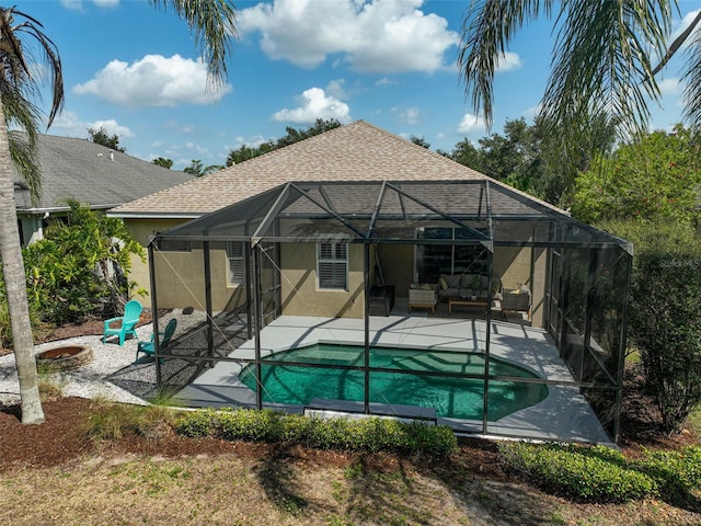 12149 Forest Park Cir, Bradenton, FL 34211 - back of property featuring an outdoor living space, a patio area, an outdoor pool, glass enclosure, and stucco siding