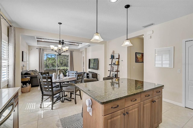 12149 Forest Park Cir, Bradenton, FL 34211 - kitchen with light tile patterned floors, a chandelier, dark stone counters, open floor plan, and a textured ceiling
