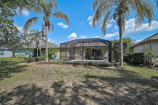 12149 Forest Park Cir, Bradenton, FL 34211 - rear view of property with a patio area, glass enclosure, and a yard