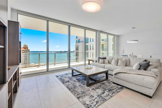 301 Quay Commons Unit 1711, Sarasota, FL 34236 - living area featuring a water view, a wall of windows, and light tile patterned flooring