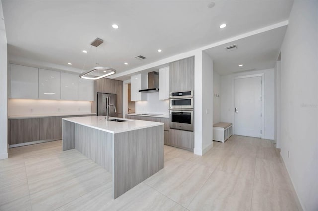 301 Quay Commons Unit 1711, Sarasota, FL 34236 - kitchen with modern cabinets, wall chimney exhaust hood, stainless steel appliances, a sink, and light countertops