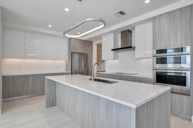 301 Quay Commons Unit 1711, Sarasota, FL 34236 - kitchen with modern cabinets, appliances with stainless steel finishes, wall chimney range hood, a sink, and white cabinets