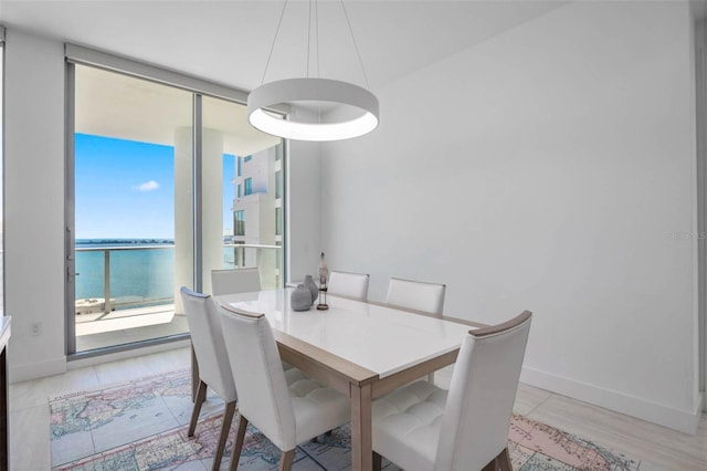 301 Quay Commons Unit 1711, Sarasota, FL 34236 - dining space with baseboards and floor to ceiling windows