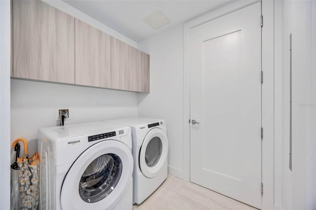 301 Quay Commons Unit 1711, Sarasota, FL 34236 - laundry room featuring cabinet space and washer and dryer