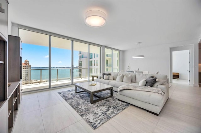 301 Quay Commons Unit 1711, Sarasota, FL 34236 - living room with a water view, a wall of windows, and light tile patterned flooring