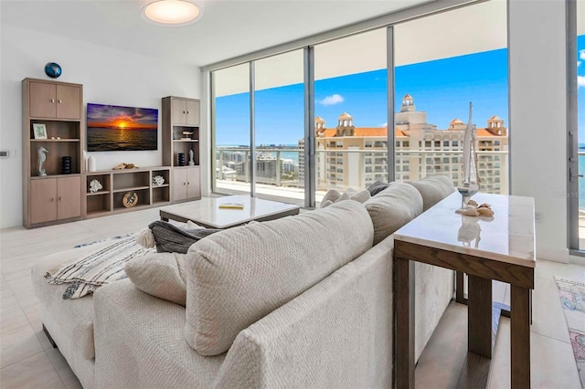 301 Quay Commons Unit 1711, Sarasota, FL 34236 - living room with light tile patterned floors and a wall of windows