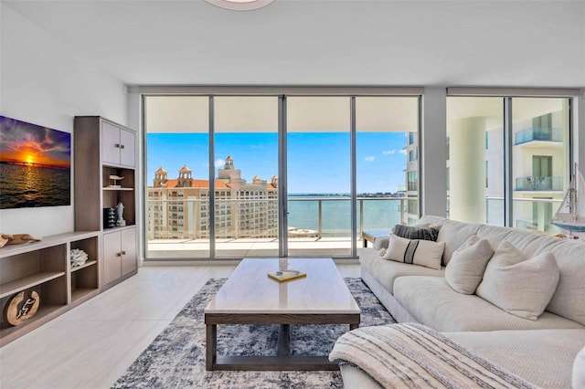 301 Quay Commons Unit 1711, Sarasota, FL 34236 - living room featuring expansive windows, healthy amount of natural light, and a water view