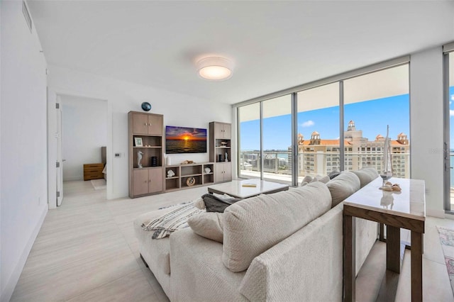 301 Quay Commons Unit 1711, Sarasota, FL 34236 - living area featuring floor to ceiling windows and baseboards
