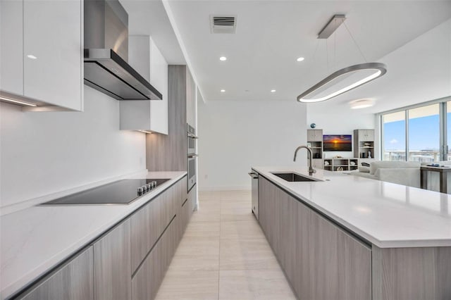 301 Quay Commons Unit 1711, Sarasota, FL 34236 - kitchen with modern cabinets, a sink, wall chimney range hood, appliances with stainless steel finishes, and a large island